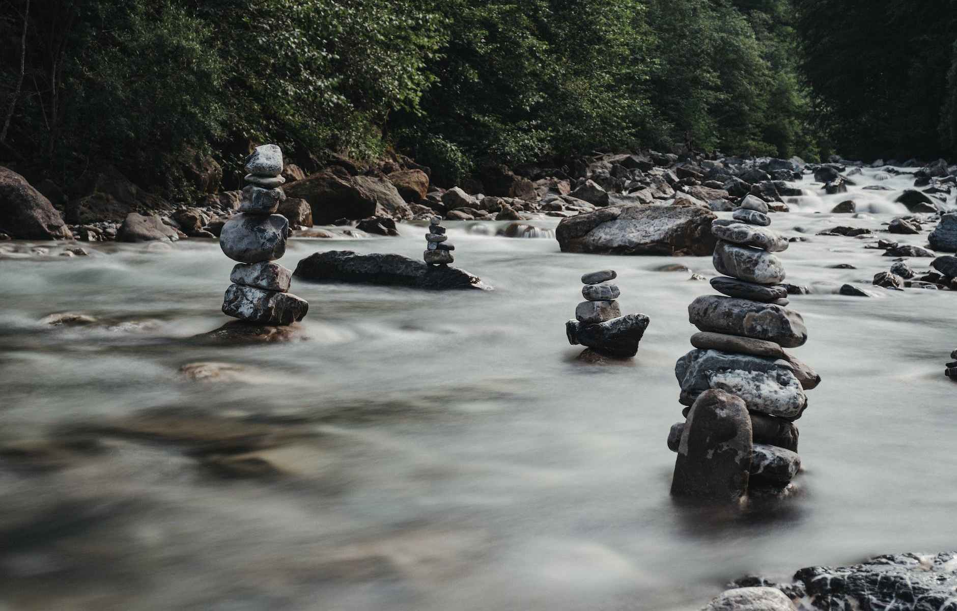 rocky pyramids in flowing river among lush trees